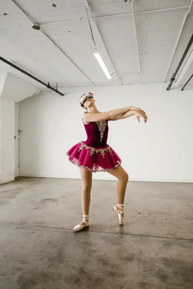 Ballet dancer in pink costume wearing virtual reality headset in modern studio setting.